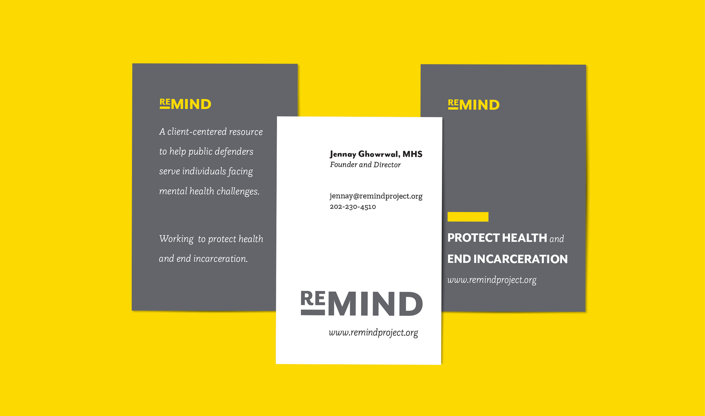 Examples of the ReMIND business cards. The front of the business cards are white with the logo and contact information, and the backs are gray with the mission station on them. They lay on yellow background.